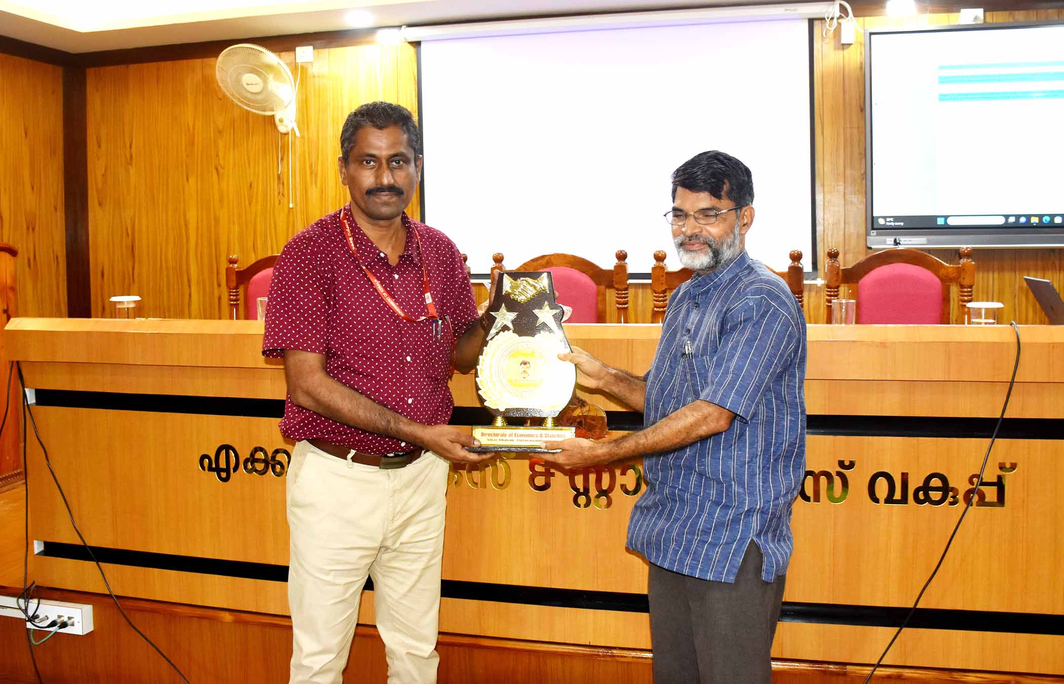 Presenting a gift to Sri. Somasekharan Pillai Prof Rtd as a token of honour